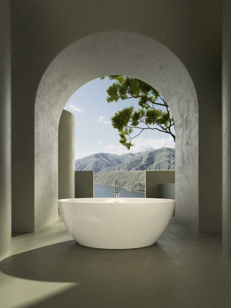 White freestanding bathtub beneath an arched window
